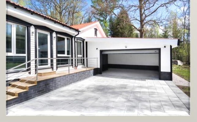 Photo of a completed single-storey villa with a double garage